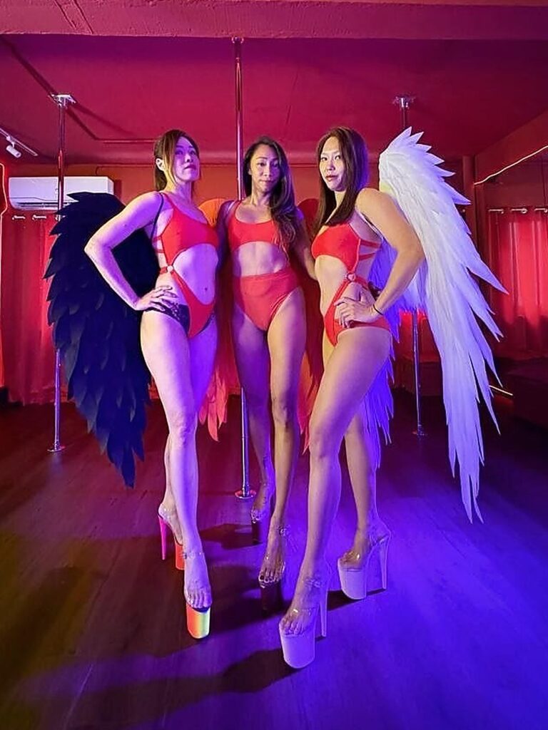 Beginner Pole Taster instructors Spectre, Vhans and Cat in angel wings in the studio